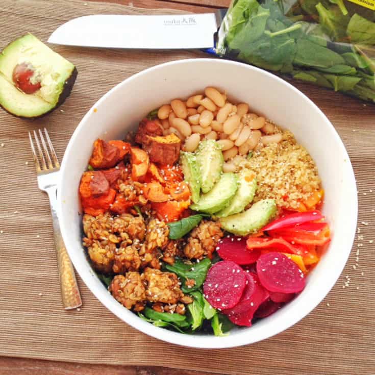 Vegan Buddha Bowl in white bowl with quinoa, tempeh, avocado, beets, peppers, sweet potatoes