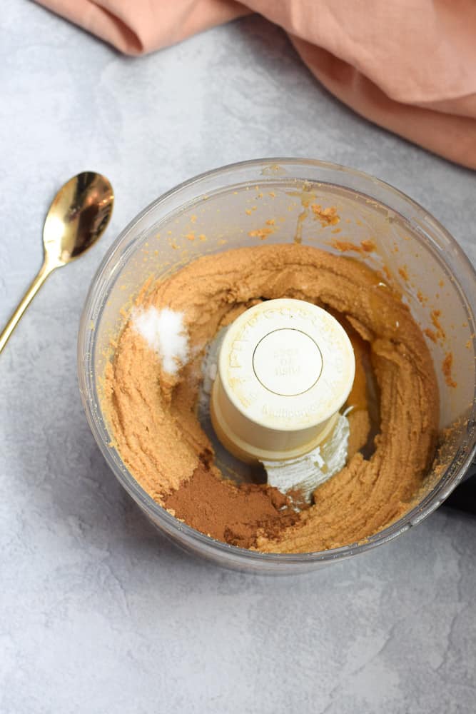 homemade cinnamon peanut butter in food processor with spices added
