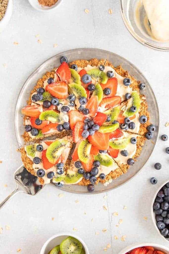 overhot shot of gluten free fruit pizza with serving spatula