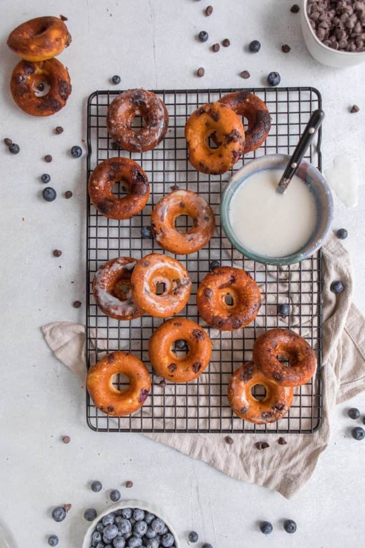 Blueberry Chocolate Chip donuts with vanilla icing on cooling rack