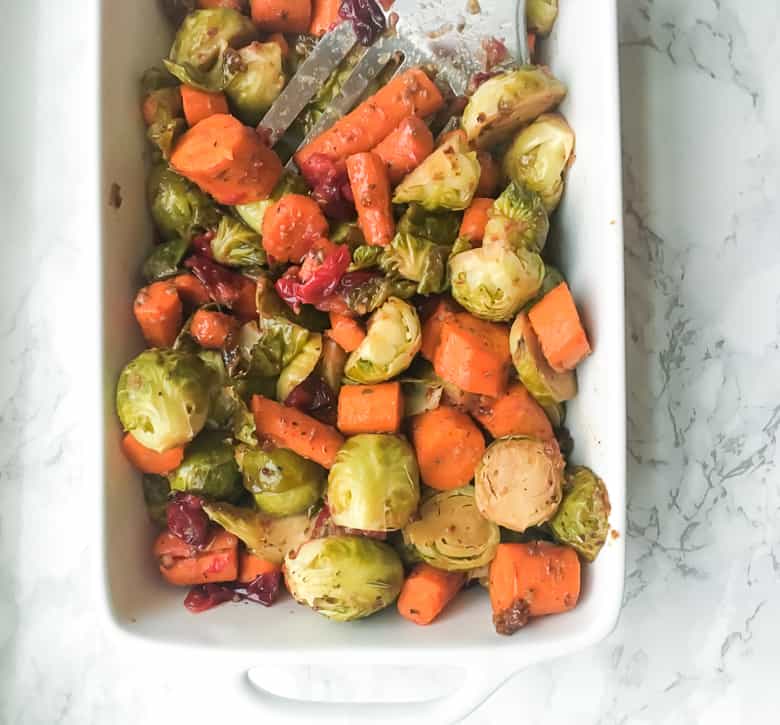 Maple balsamic brussel sprouts and carrots in white baking dish
