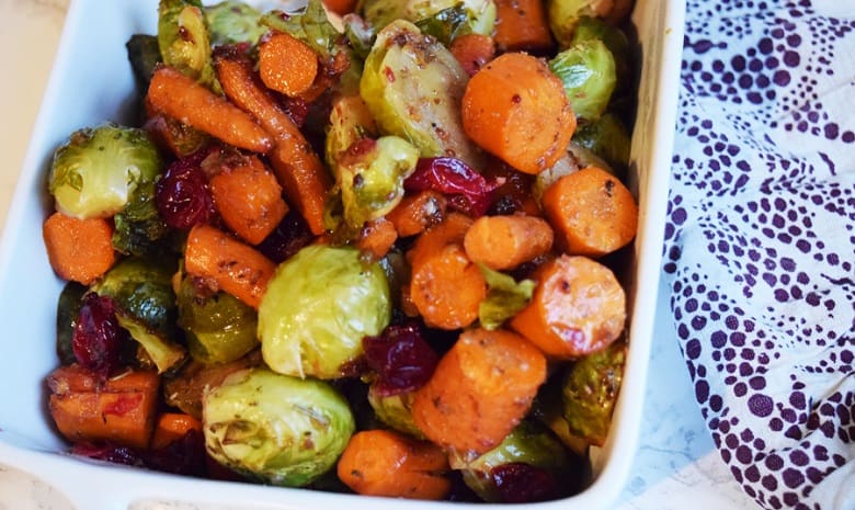 Balsamic Roasted Carrots and Brussel Sprouts with Cranberries in White Baking Dish | Bucket List Tummy