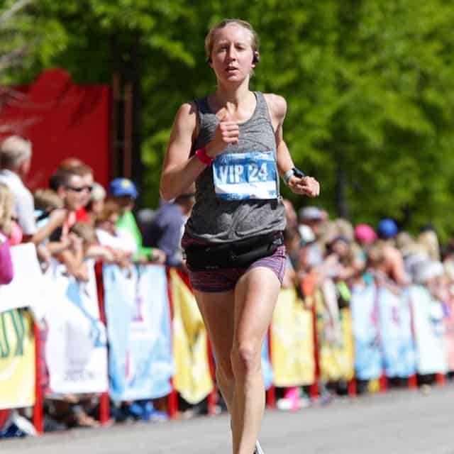 woman crossing finish line at marathon