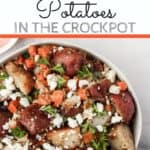 white bowl with slow cooker rosated red potatoes topped with carrots and feta cheese with text overlay | Bucket List Tummy