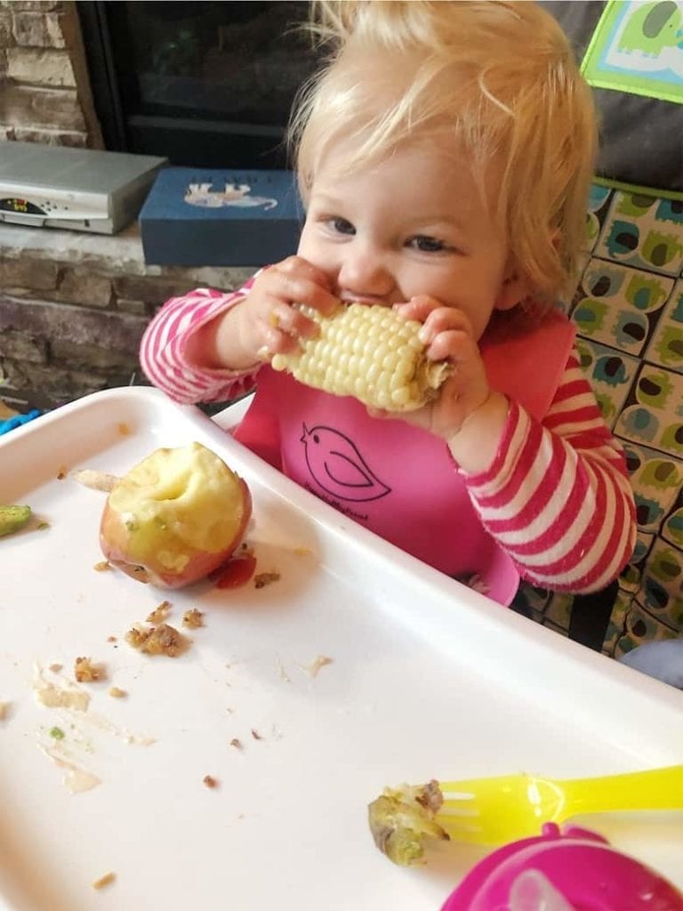 baby eating corn on the cob