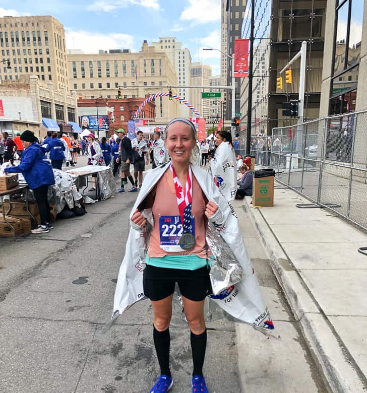 Girl holding finisher's medal at 2019 Detroit Free Press Marathon