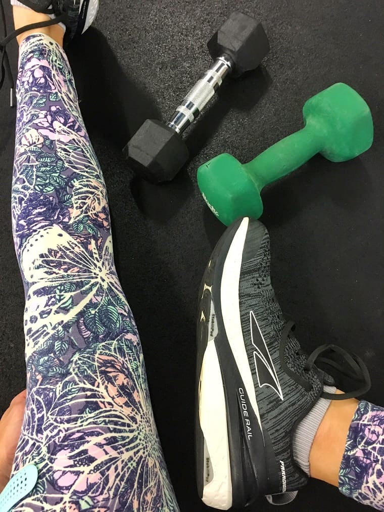 stretching with free weights on floor