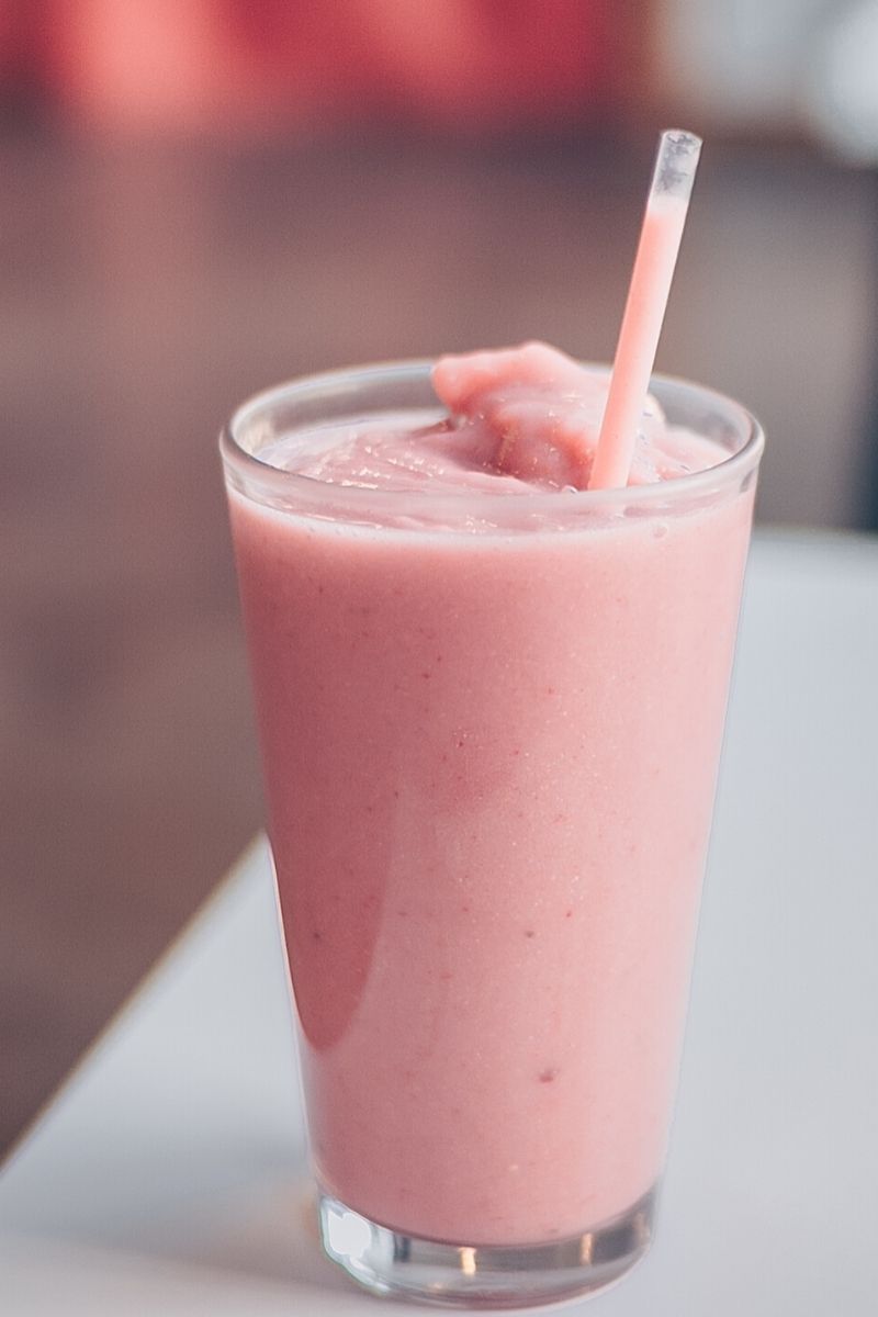 pink shake in glass with straw as leucine supplement
