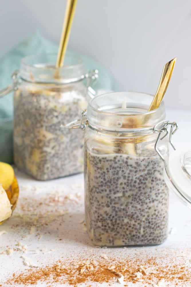 overnight chia seed pudding in mason jars with gold spoons