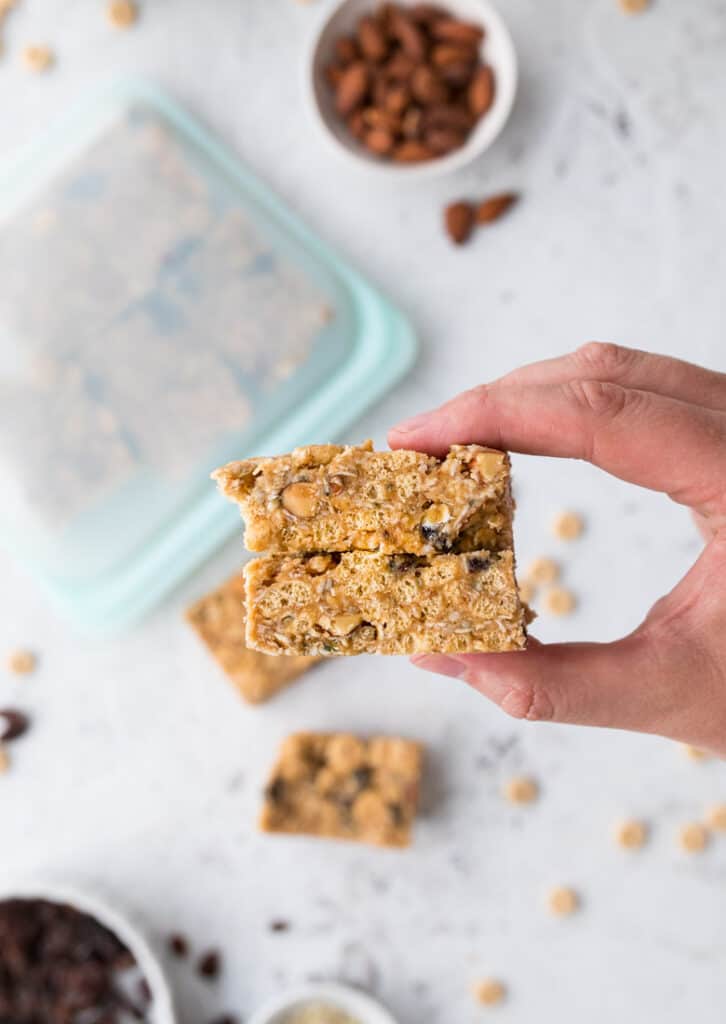 holding healthy cereal bars with peanut butter and cheerios and nuts