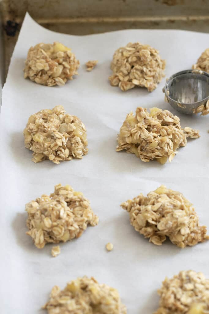 scoops of batter for peanut butter banana oatmeal cookies on baking sheet