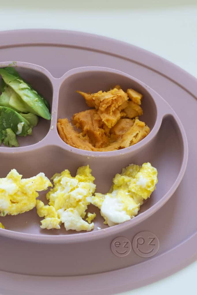 baby plate with mashed sweet potatoes, eggs and avocado