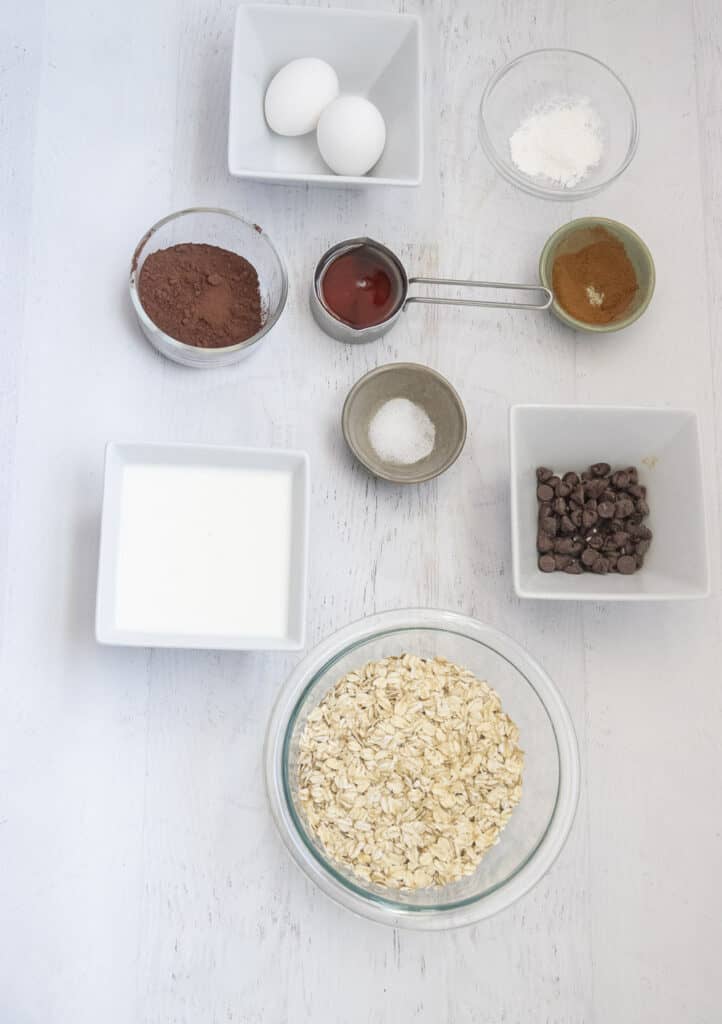 ingredients in small bowls to make chocolate baked oatmeal
