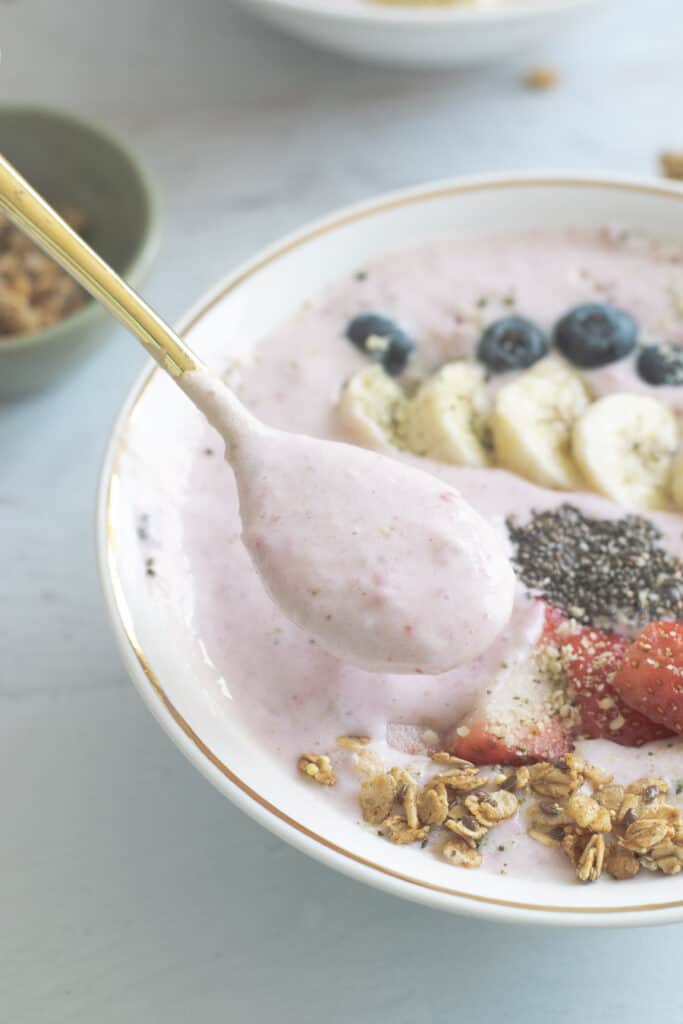 spoonful of thick strawberry banana smoothie bowl