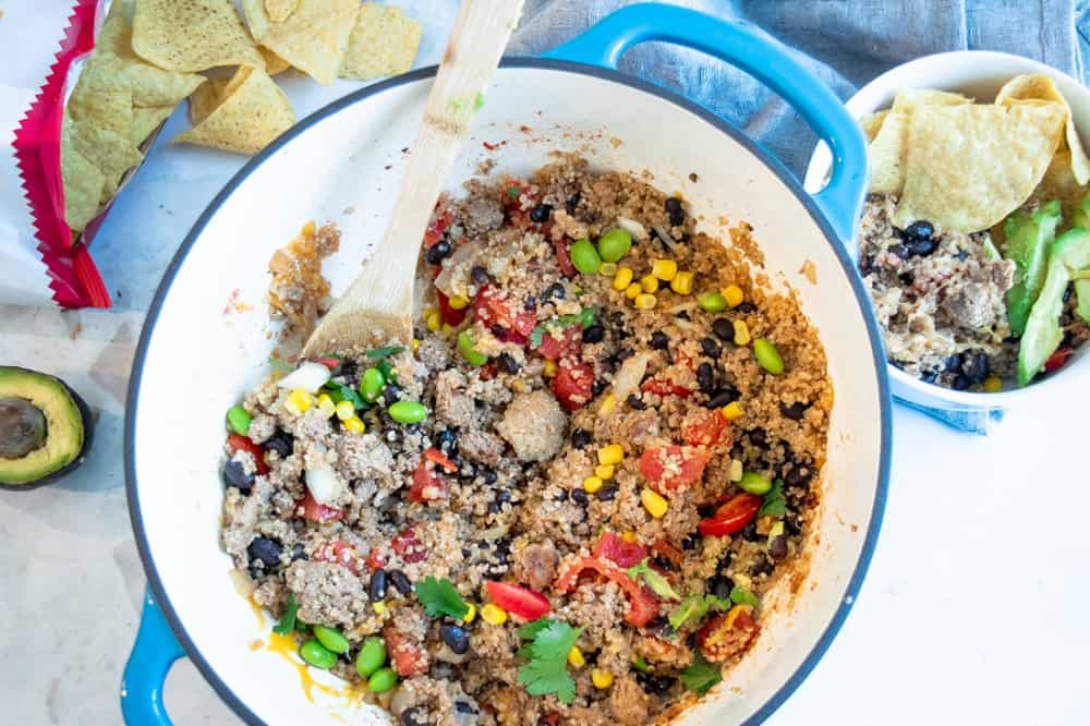 turkey taco skillet with quinoa and veggies in blue cooking pot