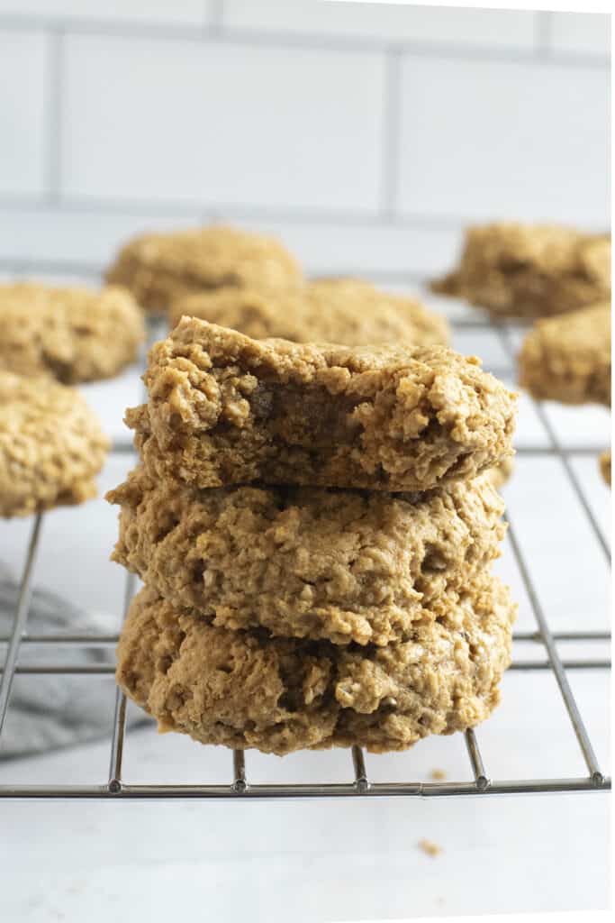 stack of three powdered peanut cookies on cooling rack
