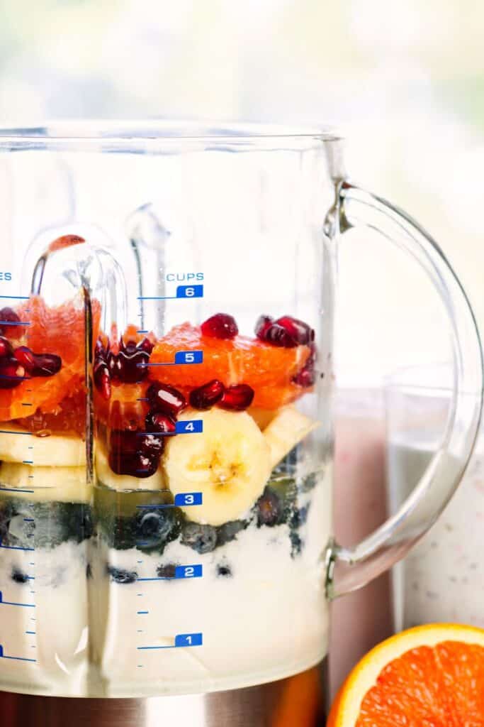 blender with fruit and yogurt to make a greek yogurt smoothie
