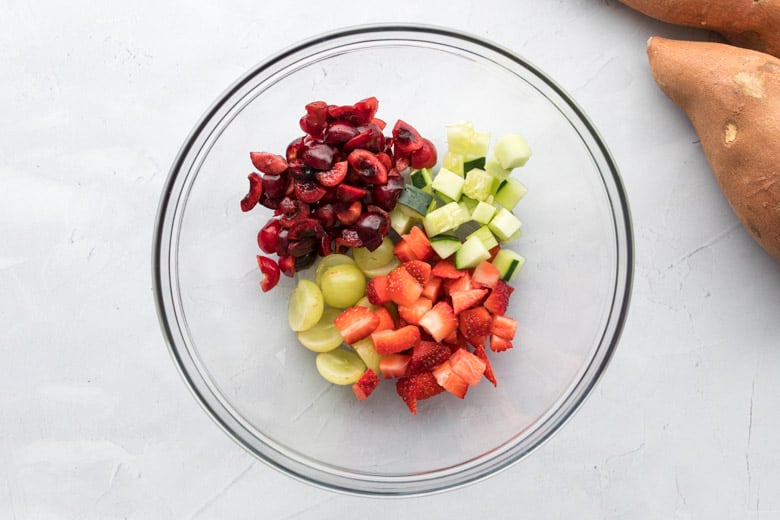 clear bowl with chopped fruit for salad