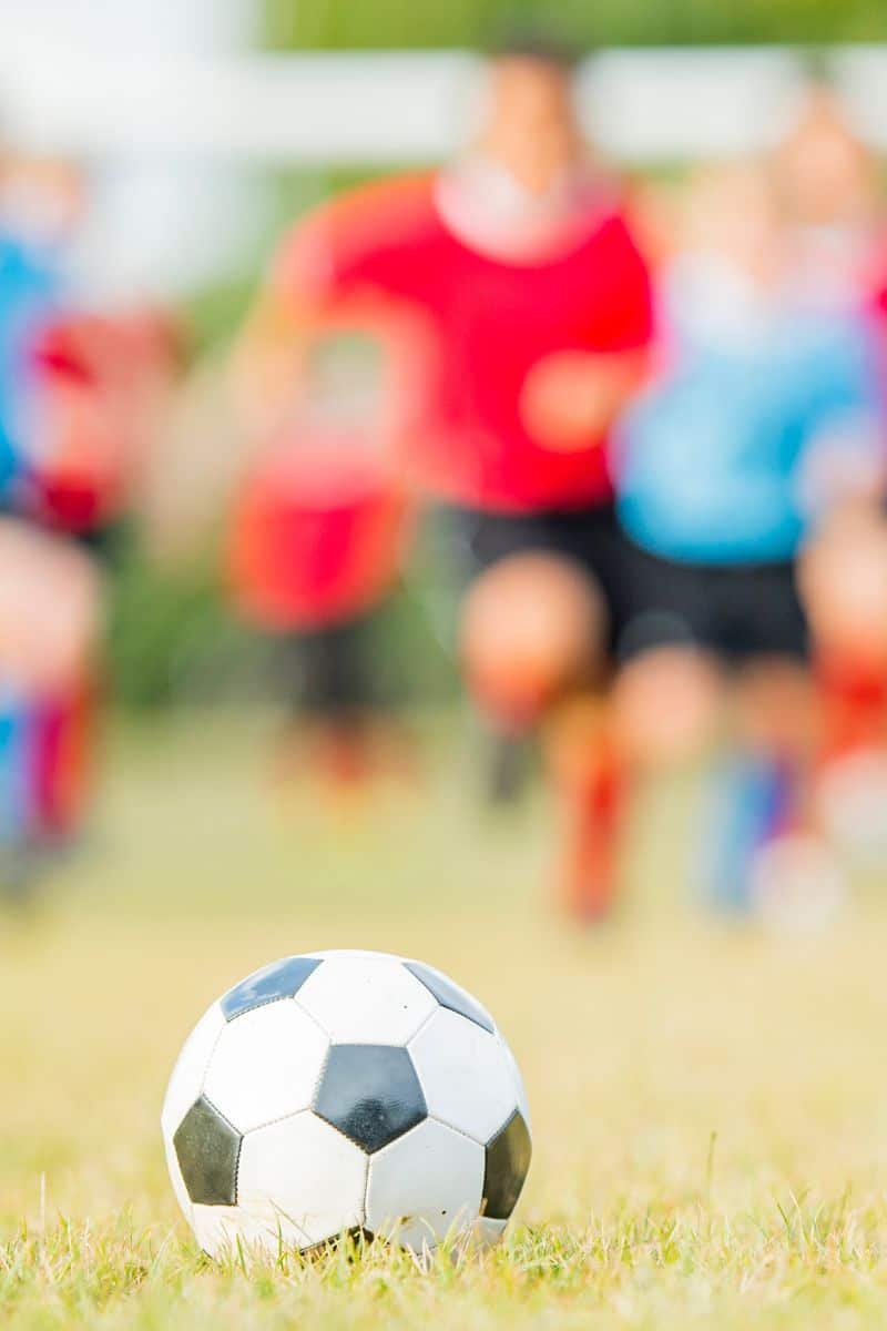 kids running after soccer ball