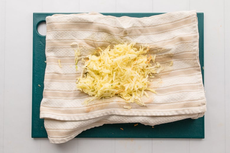 grated zucchini on cloth towel