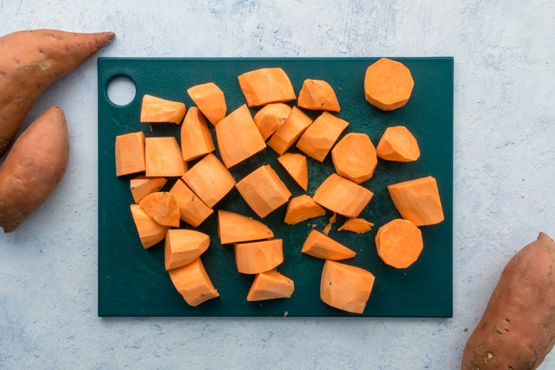 chopped sweetpotatoes on green cutting board