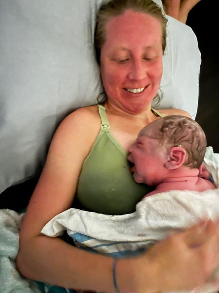mom enjoying newborn baby after home birth