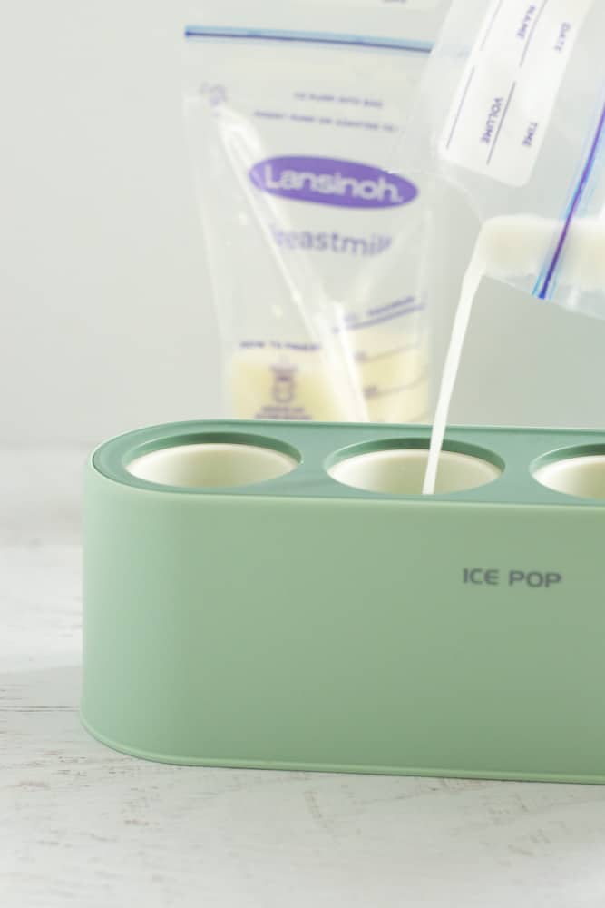pouring breastmilk into popsicle mold