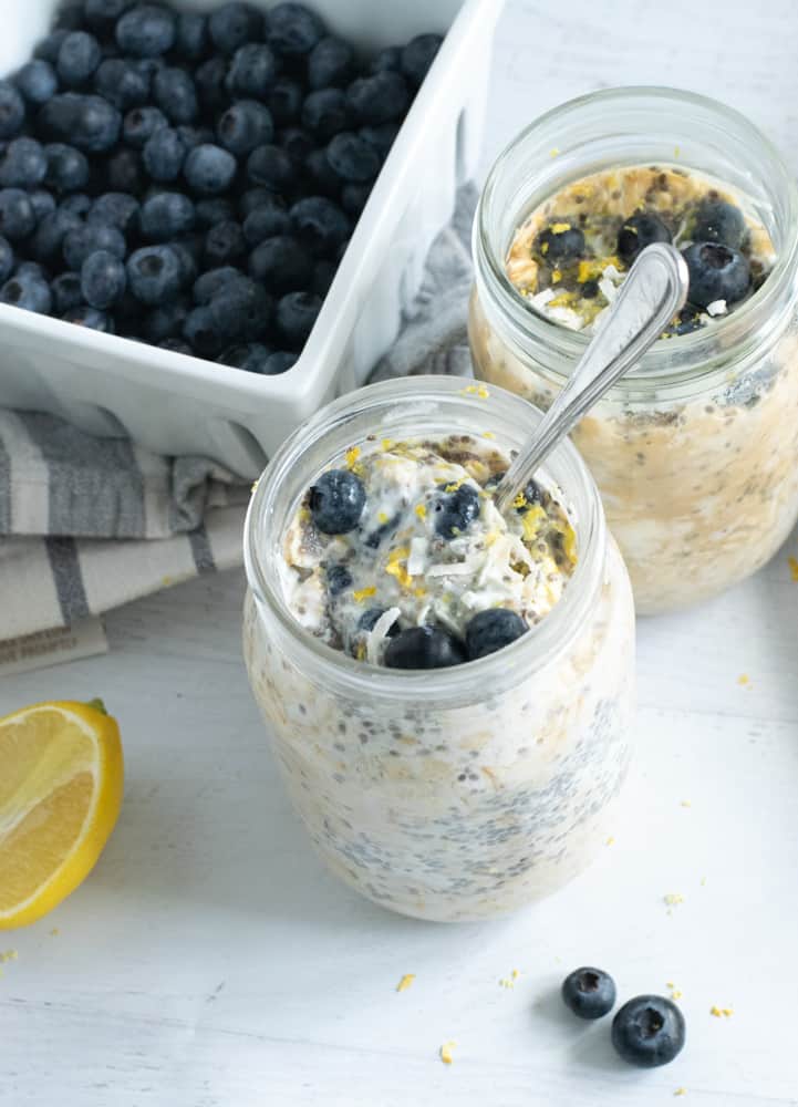 lemon curd overnight oats with blueberries in mason jars