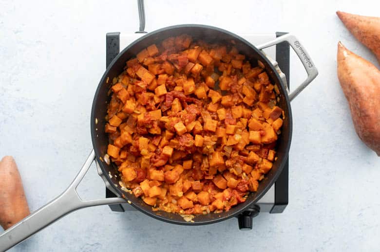 diced sweetpotatoes and canned tomatoes in skillet