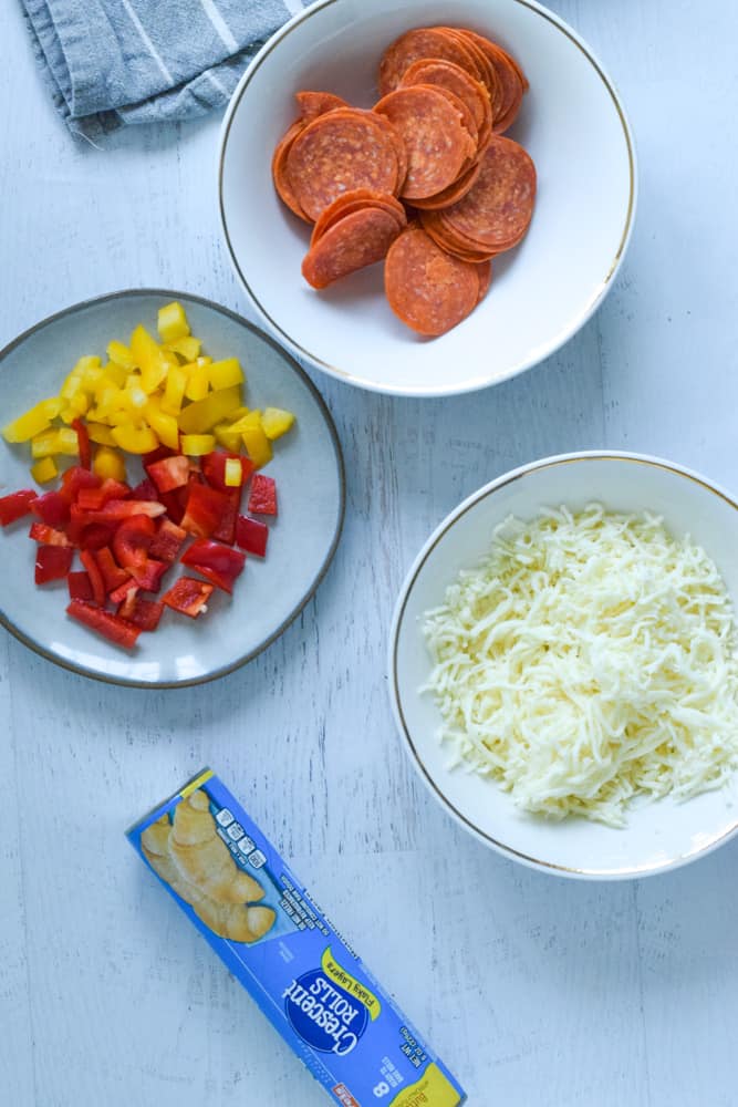 ingredients in bowls on table to make air fryer pizza bites