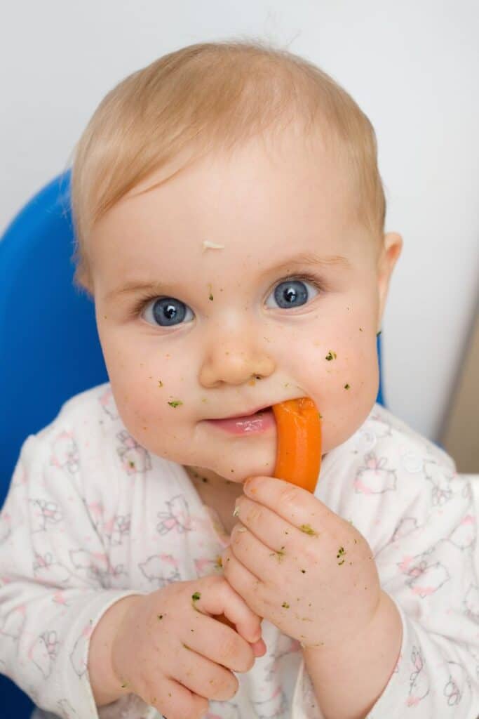 baby eating roasted carrots