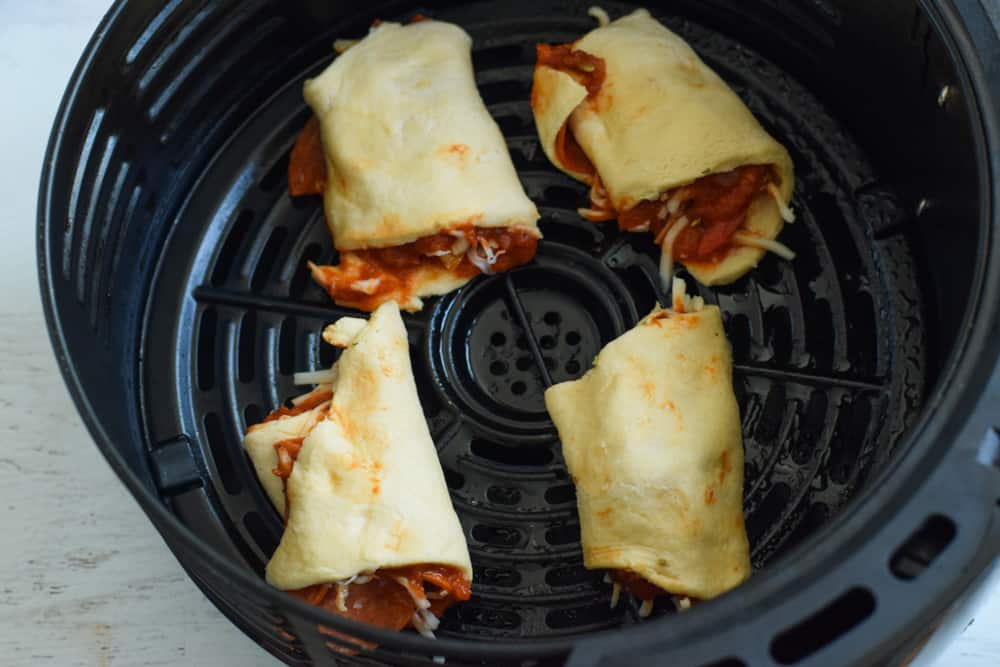 Uncooked and wrapped pizza bites in the air fryer