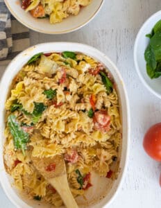 baked goat cheese pasta in white casserole dish