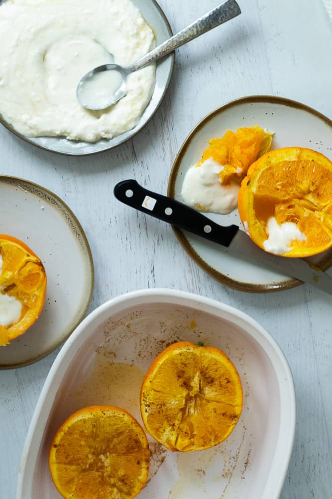 Baked oranges with honey whipped feta on plate