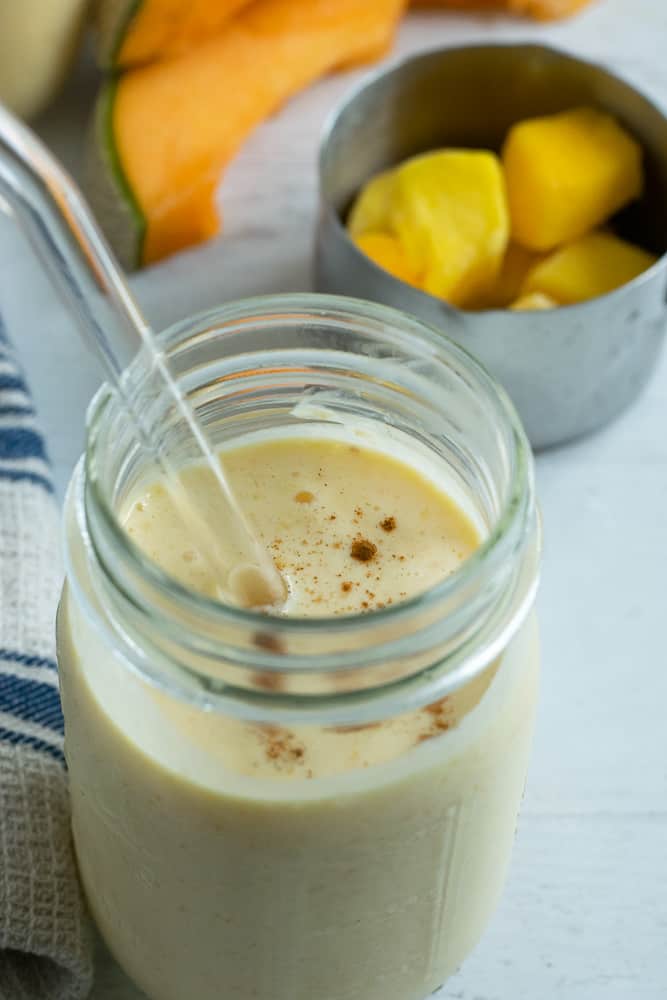 glass cup of cantaloupe mango smoothie