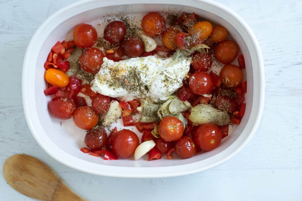 casserole pan with cherry tomatoes, goat cheese and herbs