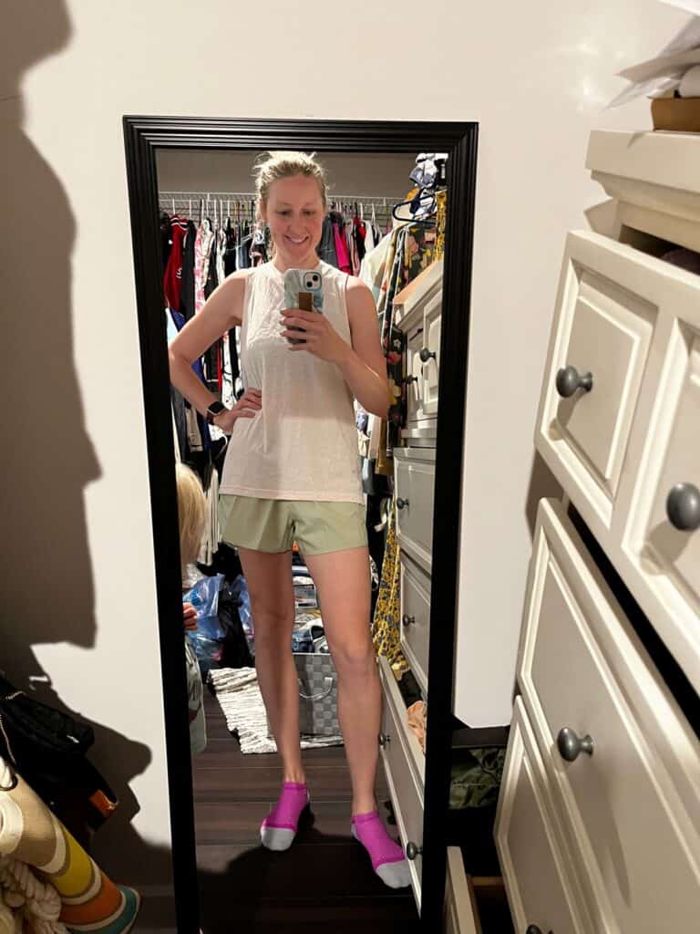 woman standing in mirror with running outfit