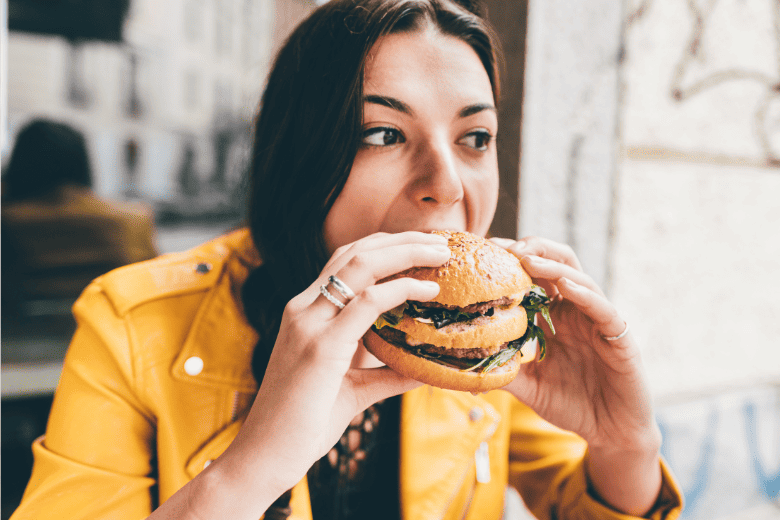 person eating cheeseburger