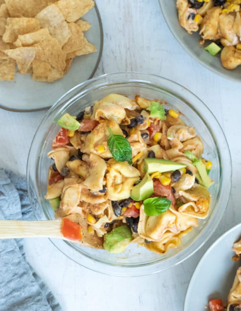 taco tortellini with veggies in clear glass bowl