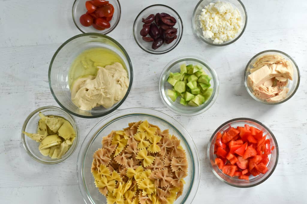 individual bowls with ingredients to make tuna pasta salad