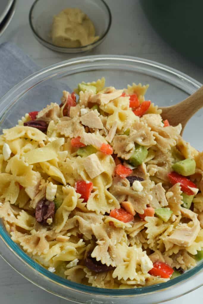 Tuna pasta salad without mayo in clear mixing bowl