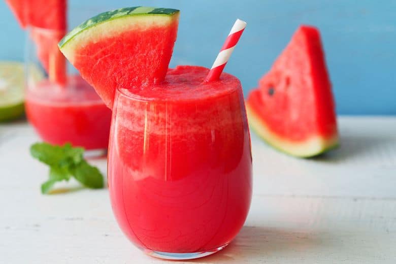 watermelon icy drink on white counter with straw