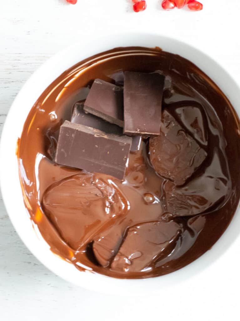 melted dark chocolate in white bowl