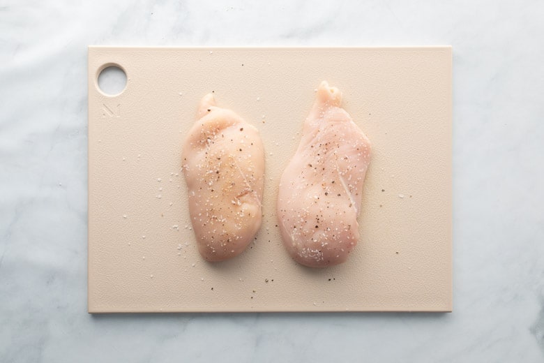 raw chicken on cutting boards