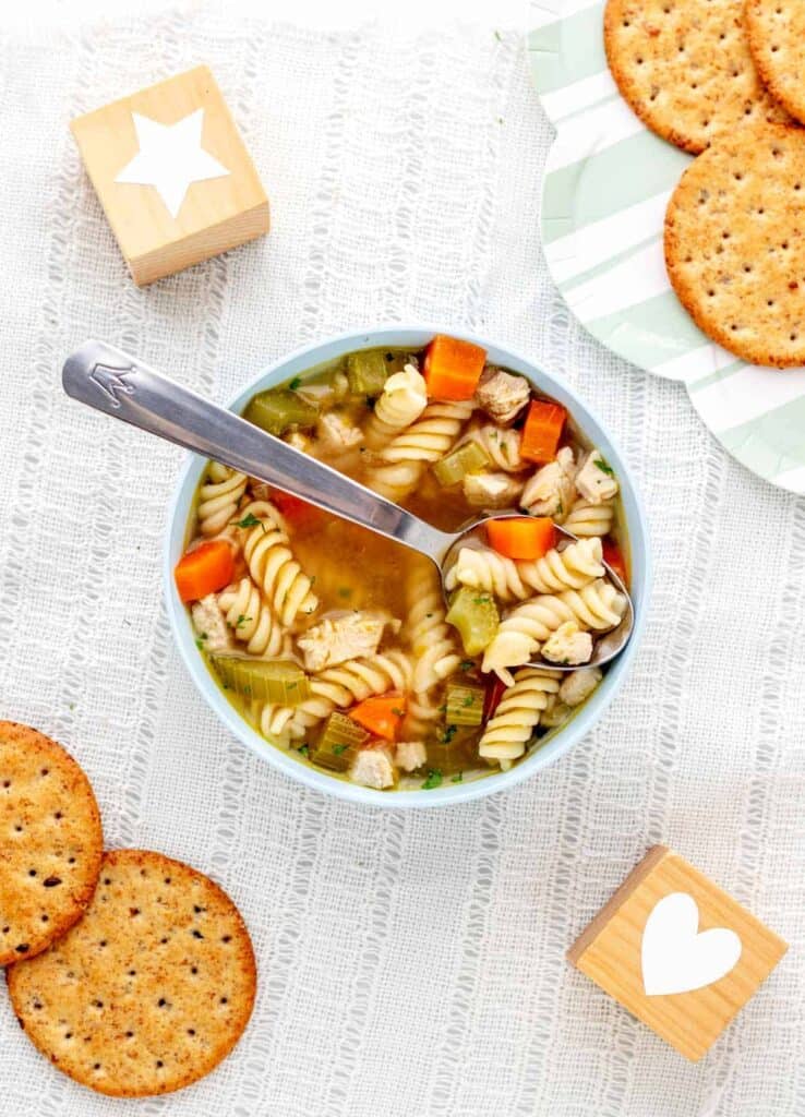 chicken noodle soup on white tablecloth