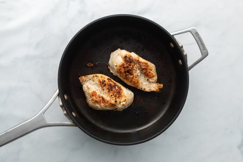 chicken breasts in cooking pan