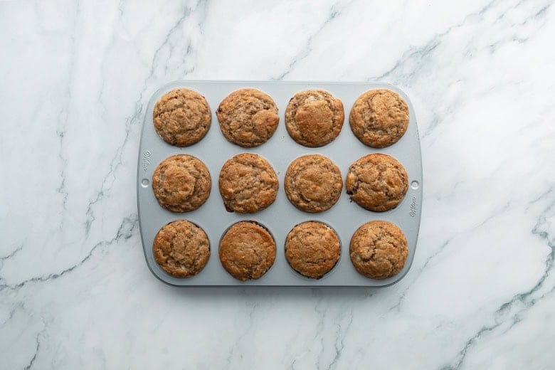 Freshly baked banana and cottage cheese muffins in a gray tray
