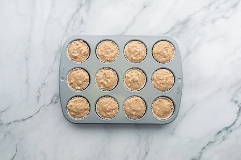 Banana and cottage cheese muffin batter in a baking pan on countertop.