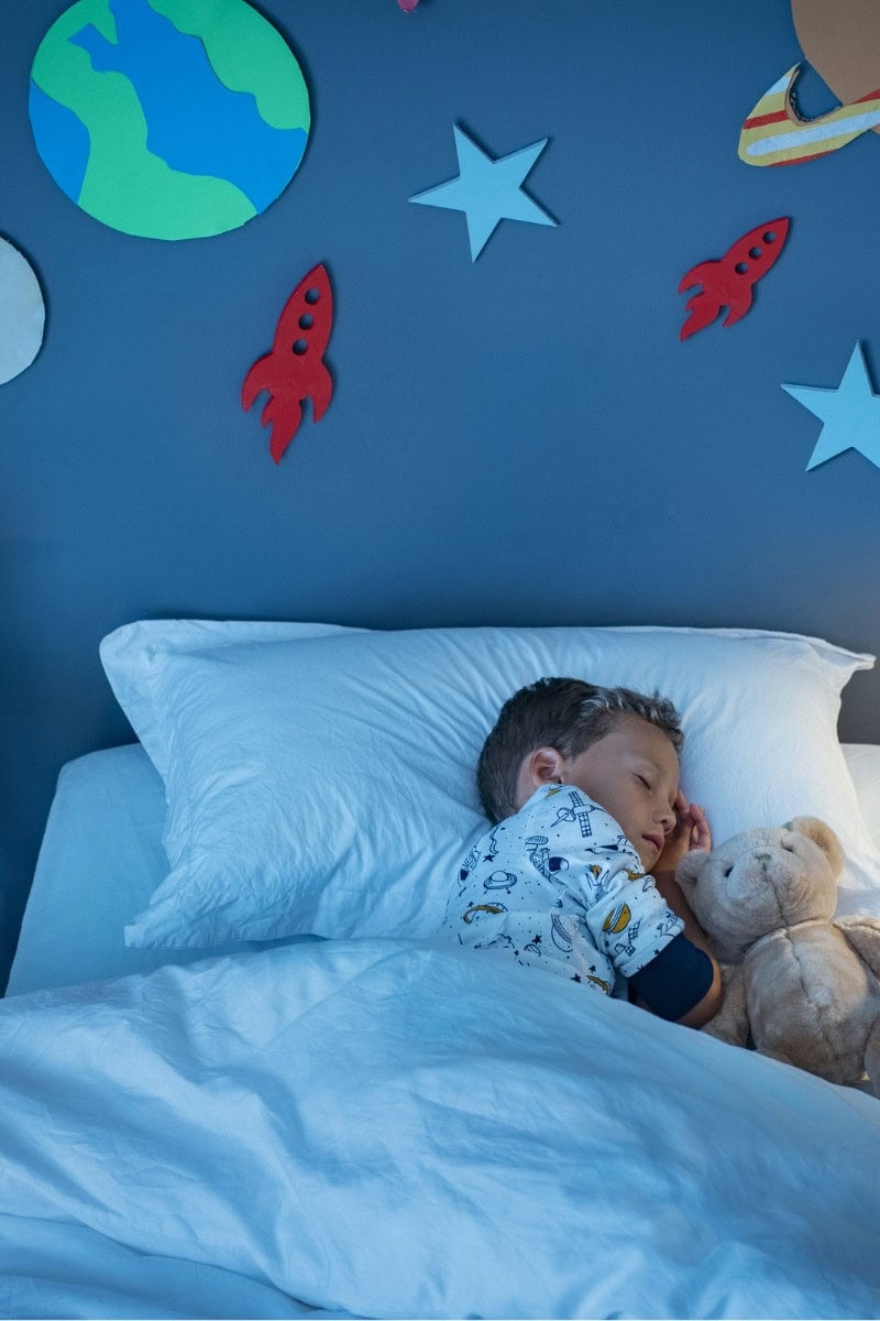 toddler sleeping in bed