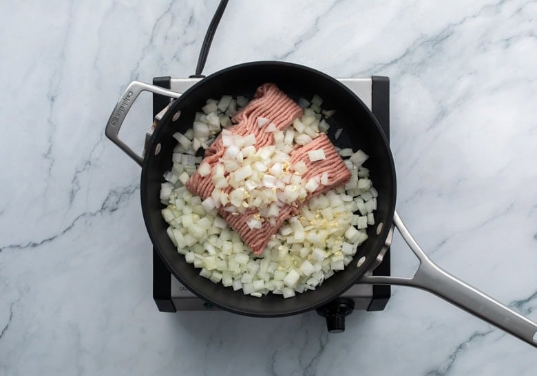 cooking ground turkey and sweet potatoes on skillet